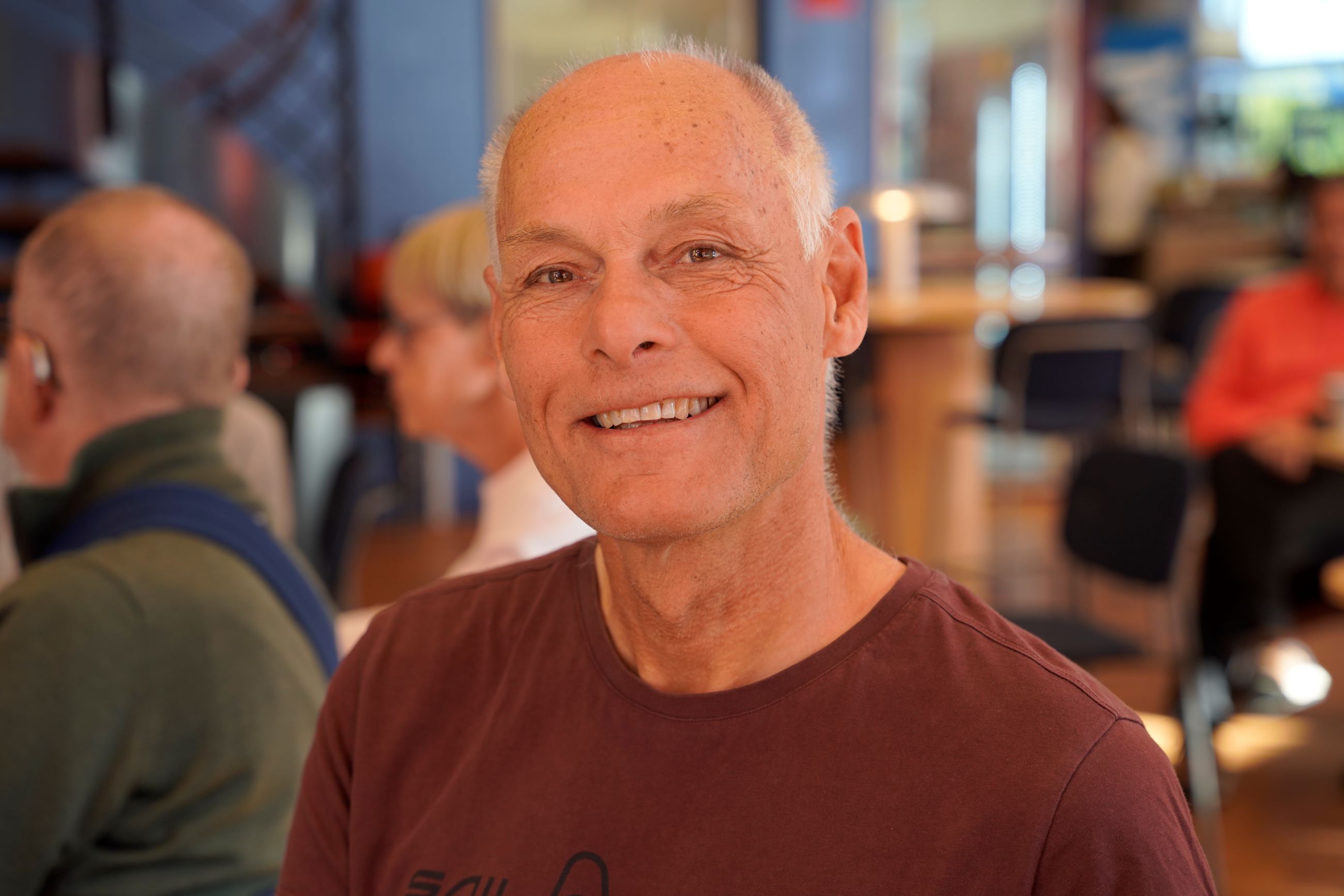 Smiling senior man at a lecture.