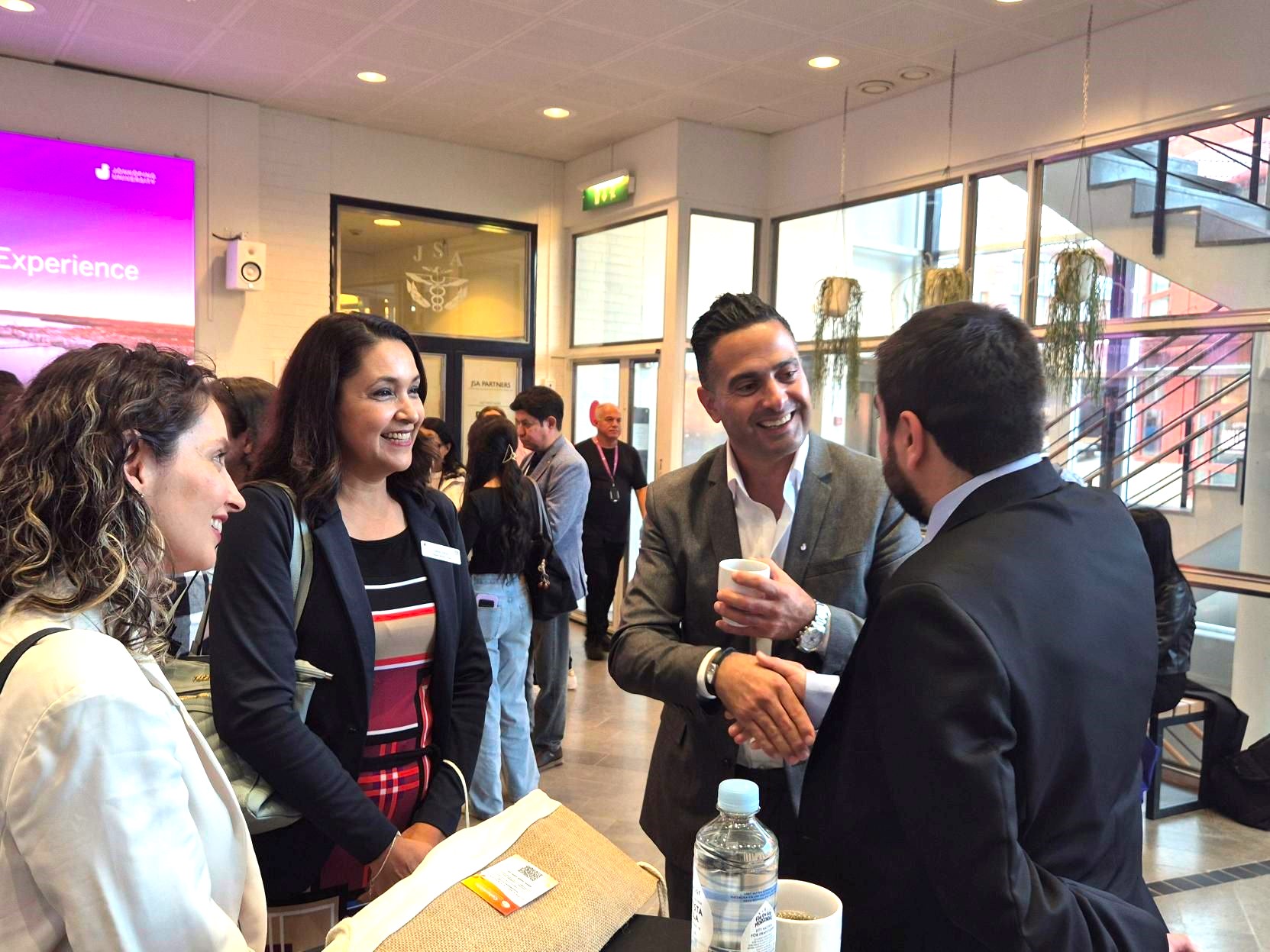 People in a conversation at a conference.